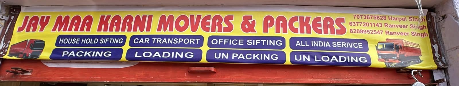 Jay Maa Karni Movers and Packers signboard listing household shifting, car transport, office shifting, all India service, packing, loading, unpacking and unloading